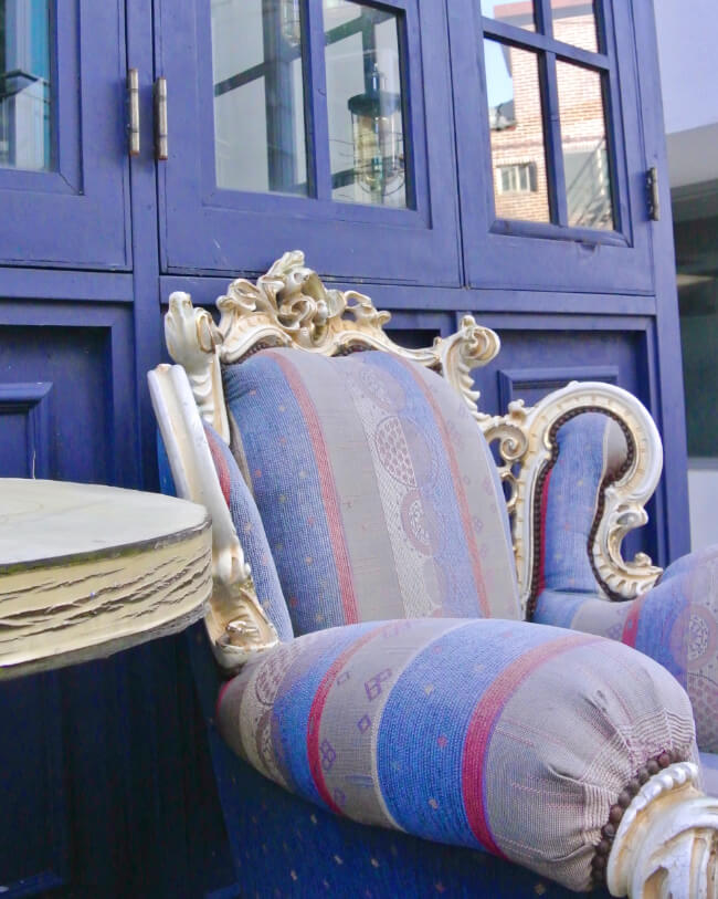 Queen Anne chair featuring stripes in periwinkle, cobalt blue, and burgundy: The dynamic visual appeal of this chair is enhanced by the artistic fusion of colors and captivating stripe and geometric patterns.
